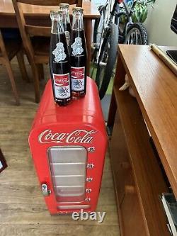 Coke machine. With 3 Olympic Coke Bottles