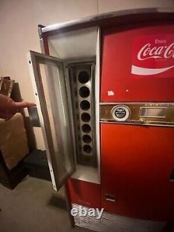 Large Red 1962 antique coke machine. Still works, comes with key